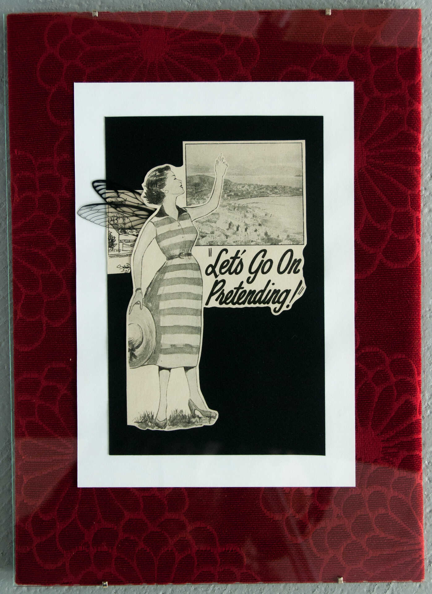 Collage 'Let's Go On Pretending' by Libby Bloxham. A vintage book illustration is layered over black and white card and framed by rich red vintage fabric with a floral texture. The illustration shows a woman in a sundress, holding a sunhat in one hand and waving to something in the distance, with an inset panel depicting a scenic coastal landscape behind her. Acetate insect wings have been added to the woman's back.