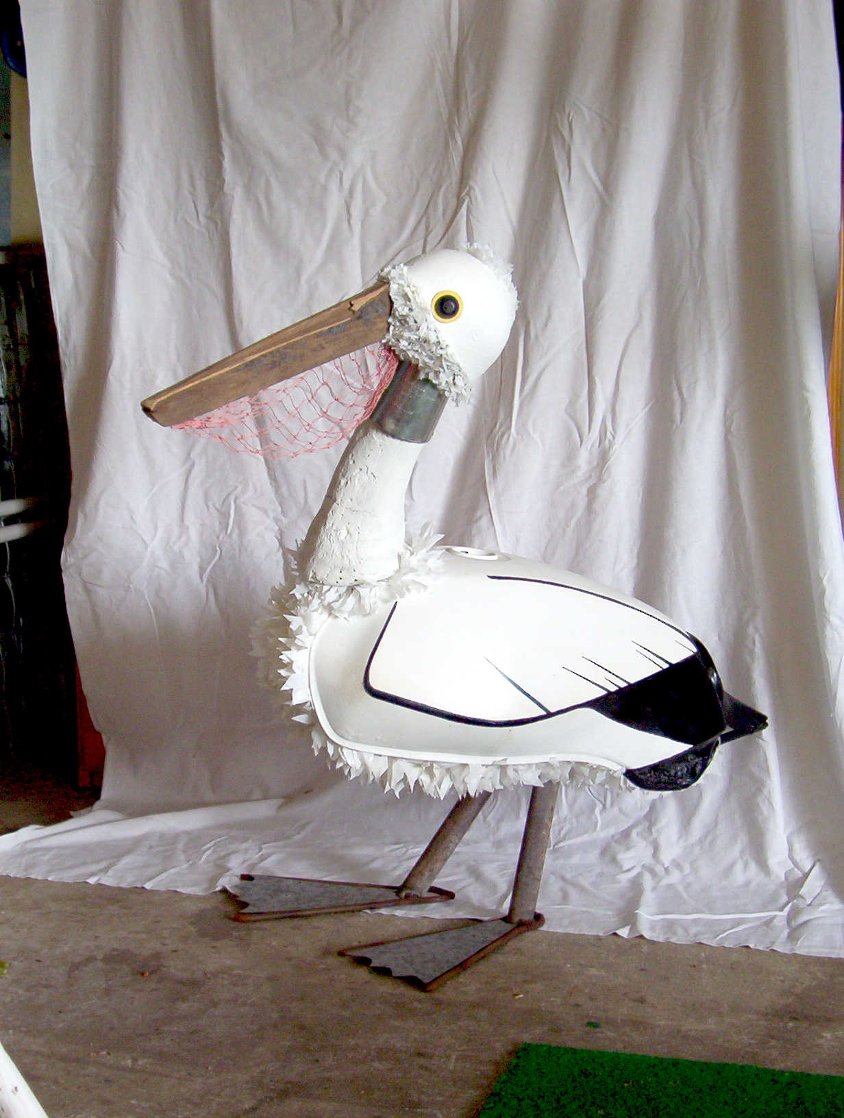 Pelican from 'Waterbirds' by Libby Bloxham. This sculpture is assembled from found and recycled objects including a motorbike fuel tank and mesh produce bags, drawing attention to the troubled relationship of human behaviour with our surrounding wildlife.
