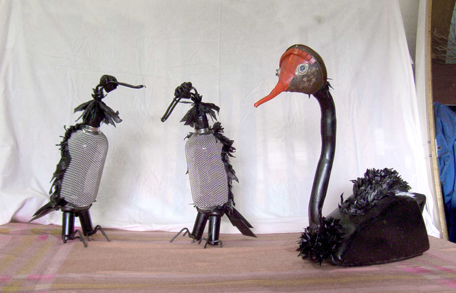 Black swan and two shags from 'Waterbirds' by Libby Bloxham. These sculptures are assembled from found and recycled objects including fuel tanks, spray bottles and plastic bags, drawing attention to the troubled relationship of human behaviour with our surrounding wildlife.